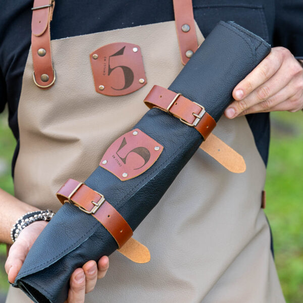 Chef wearing a Chilli No. 5 apron holding a Chilli No. 5 knife pouch set